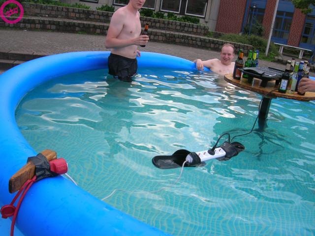 Flip Flop Holding Electrical Cord in Pool